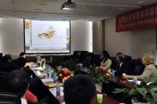 A demonstration of the Virtual Taxonomy Laboratory in Beijing being watched by (on right) Dr John Stocker and Dr Megan Clark.