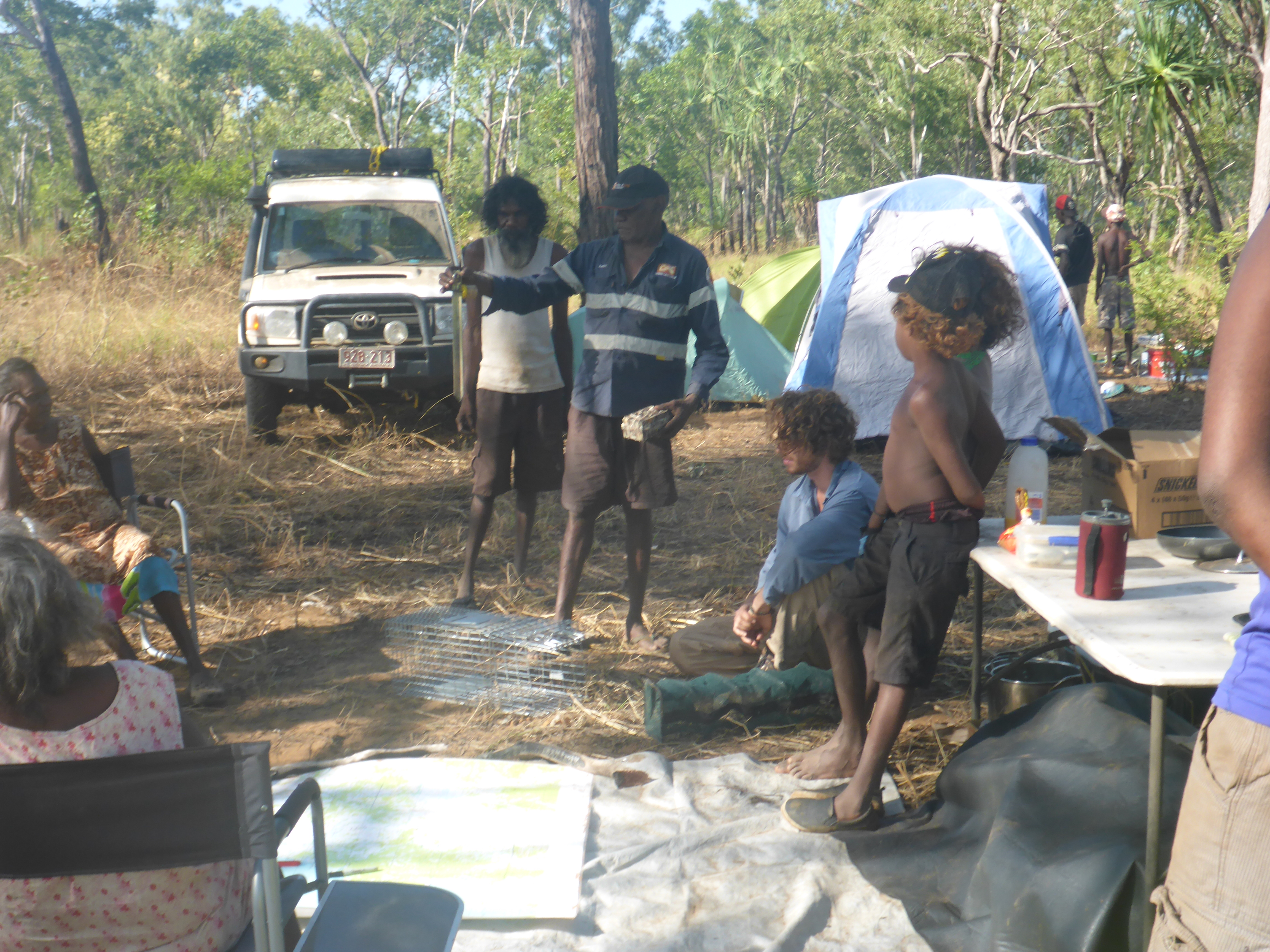 Clarry Rogers (Yugul Mangi Ranger Coordinator) and Winston Thompson (Ngandi Traditional Owner and Yugul Mangi Ranger) describing the different trapping methods and sites to be used in the survey, with (from left to right) Cherry Daniels (Ngandi Traditional Owner), Marjorie Daniels, Mitchell Scott (Macquarie Univeristy), Kelvin Lingiari and Clancy Turner.