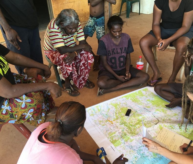 People sitting around a map